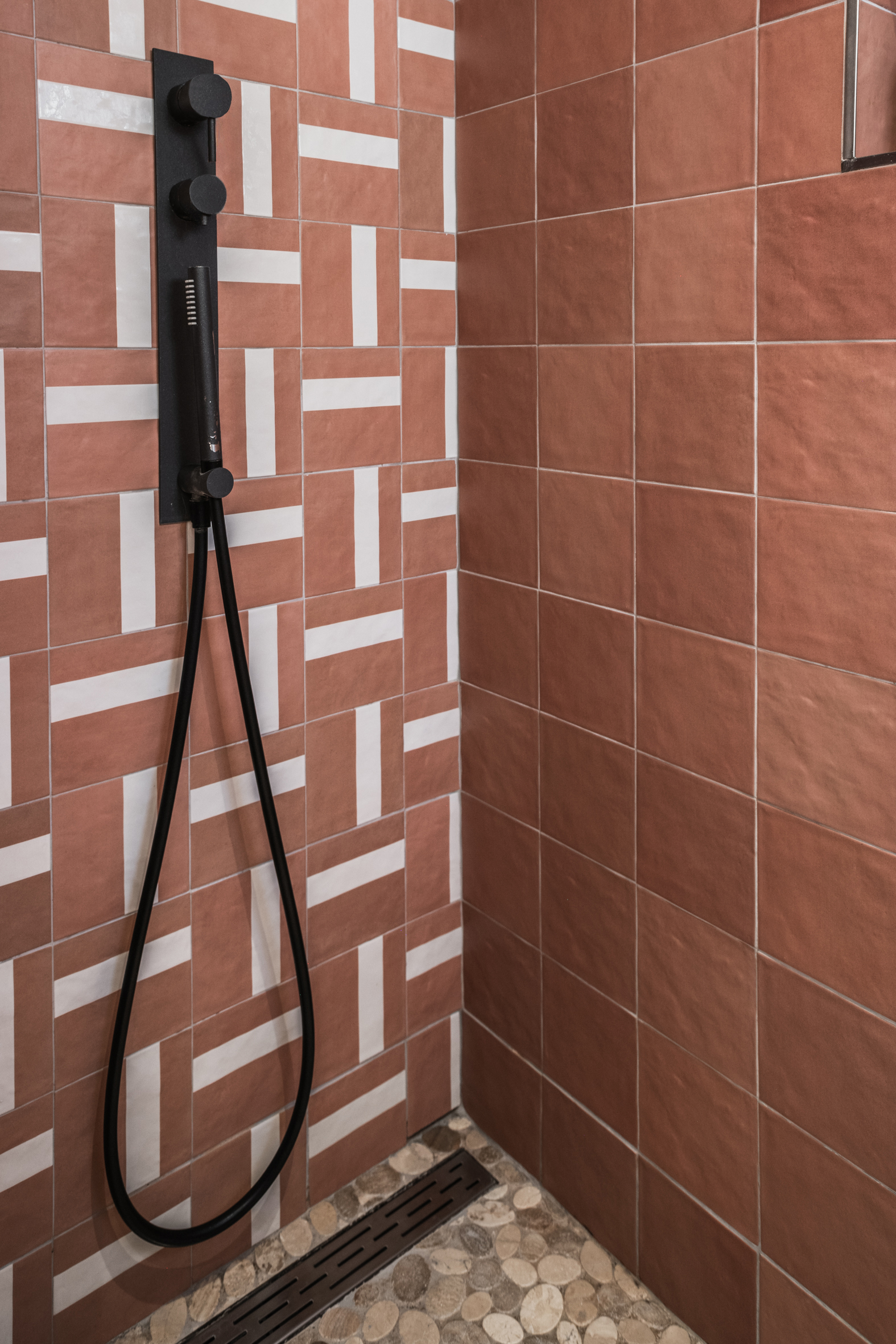 Stylish bathroom at CASA KALU with modern red tiles, rain shower